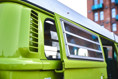 Have a green and white car during the day
